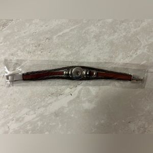 Leather style snap it bracelet with silver colored details.